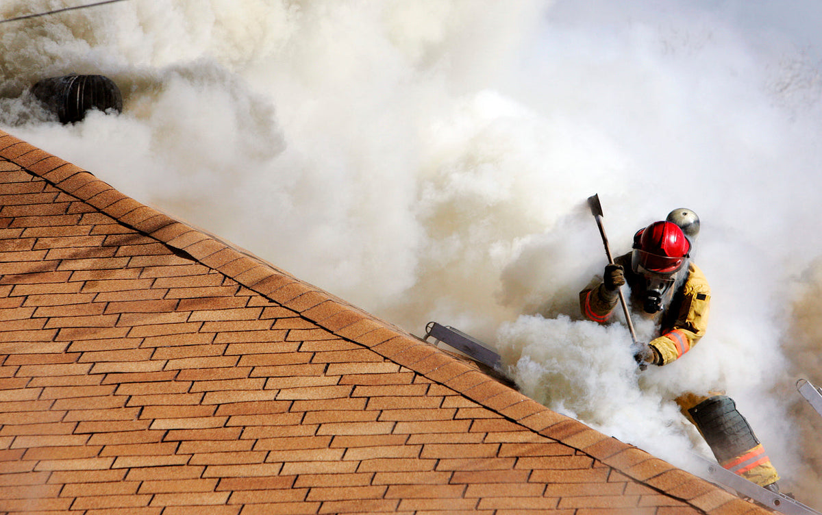 Firefighter ventilating a smoke-filled roof
