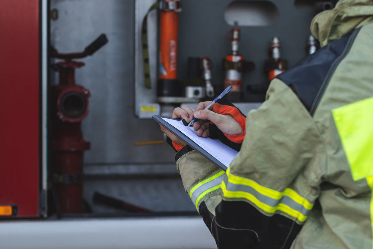 Firefighter checking an equipment checklist for a new engine company