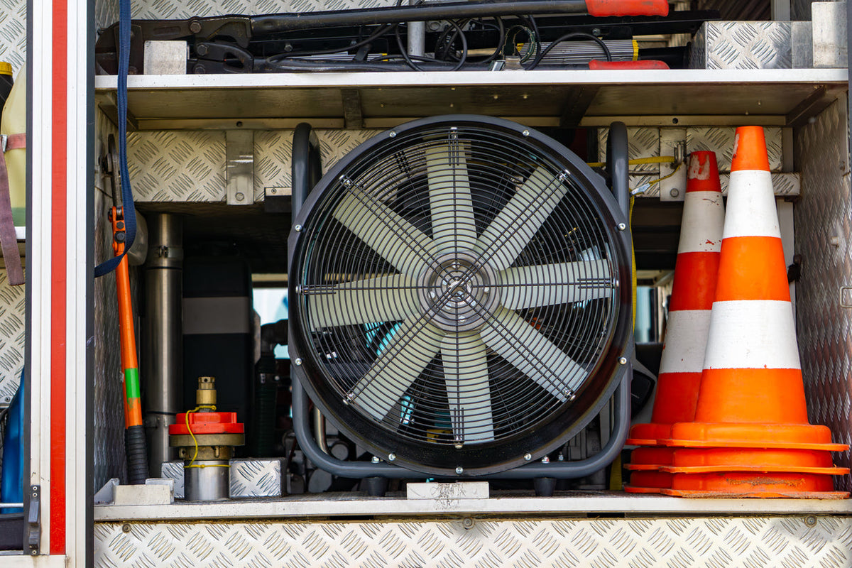 PPV fan stored in a fire apparatus compartment